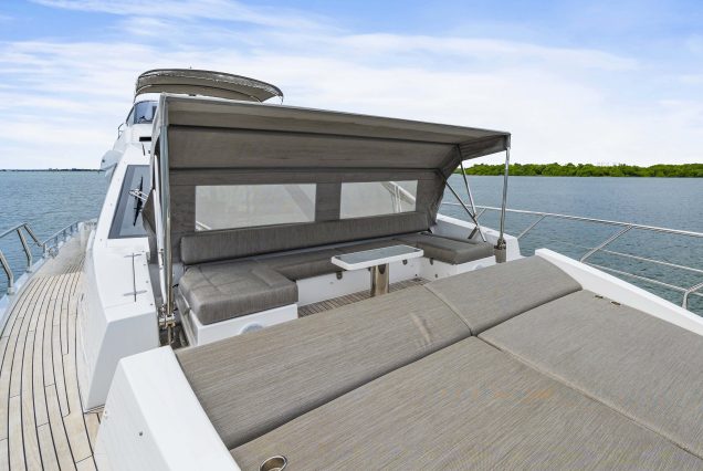 72ft Azimut “Water You Doing” luxury yacht available for charter in Miami with VIP seating area at the bow with shaded cover.,
