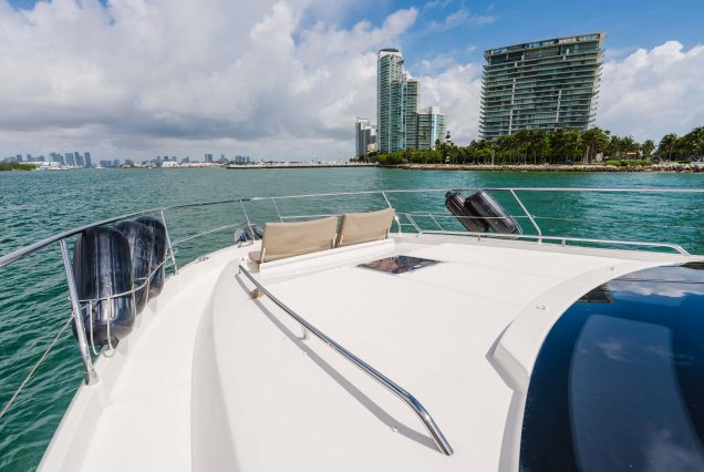 World Wide 62ft Prestige Yacht bow seating area with scenic waterfront views