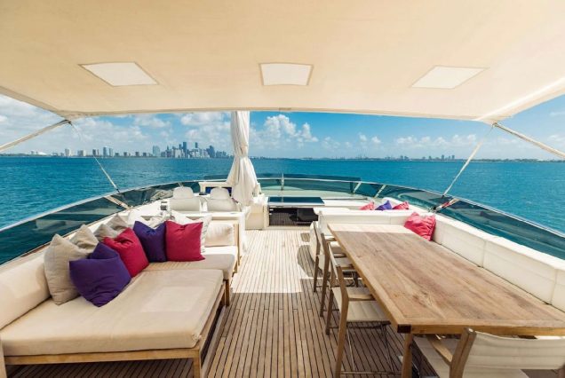 Luxury 110ft Dominator Senay Miami upper deck seating with table for fine dining and cocktails