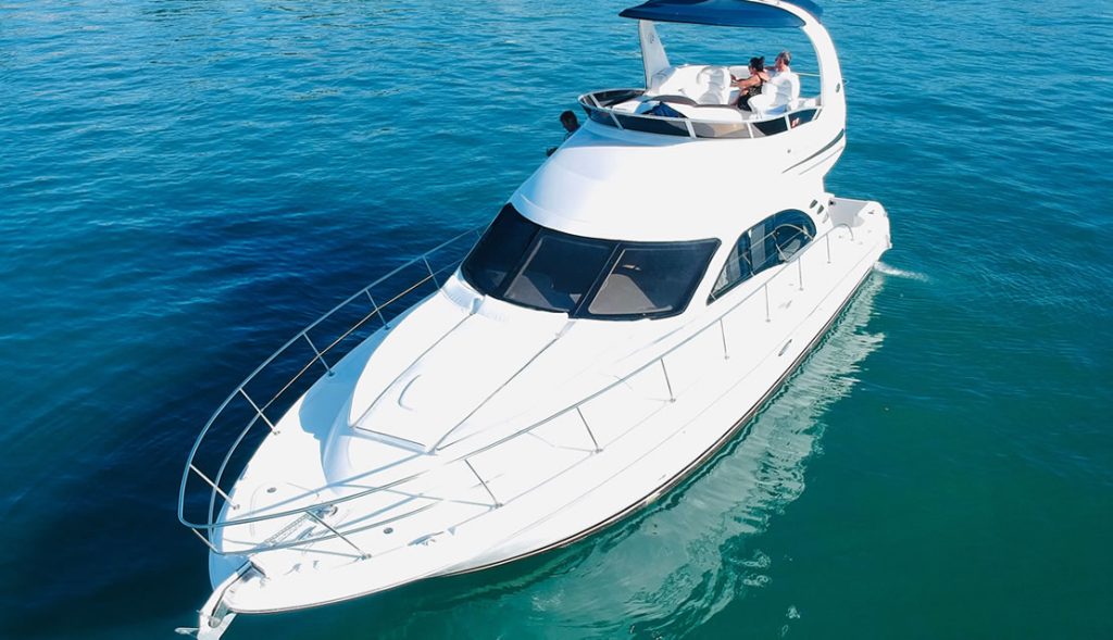 Modern 50ft White Ace Sea Ray Yacht front deck seating with beautiful waterfront views