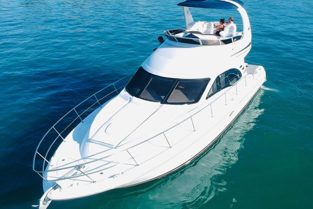 Modern 50ft White Ace Sea Ray Yacht front deck seating with beautiful waterfront views