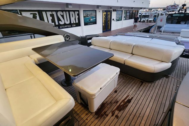 Luxury 64ft Pershing Wind Miami smooth boarding access main deck with comfortable seating and table