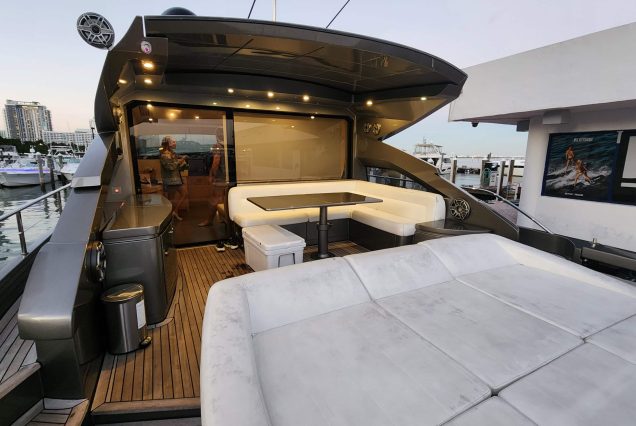 Luxury 64ft Pershing Wind Miami smooth boarding access main deck with comfortable seating and table