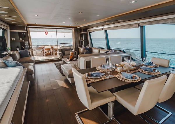 Top Shelf 87ft Ferretti Miami stylish lounge with table for social gatherings and entertainment