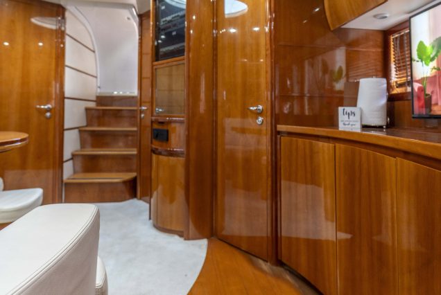 Velocity 50ft Pershing Miami sophisticated indoor salon with modern seating and elegant décor