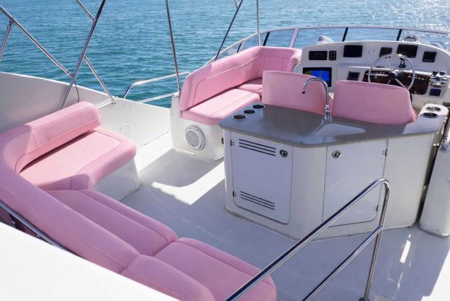 ESCAPE PINK 47ft Silverton Miami upper deck seating with table for drinks and gatherings