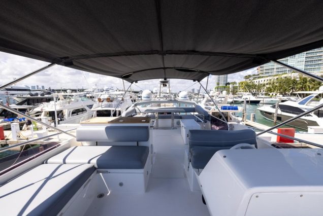 Modern 65ft Numarine Sebastian Miami flybridge setup with cooler for refreshments