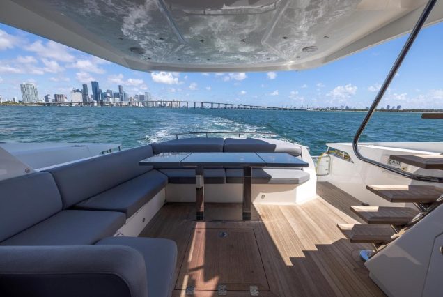 Modern 65ft Numarine Sebastian Miami smooth boarding access to the upper deck with amazing seating area and table.