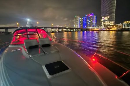 Sun-kissed 45ft Sea Ray Yacht front deck seating with beautiful waterfront views with sunbed area.
